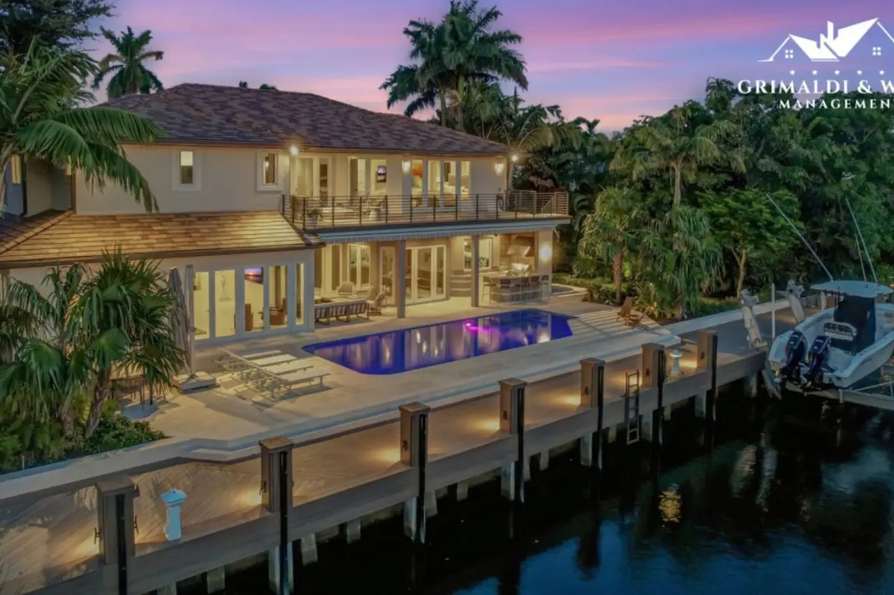 Outdoor dining space with waterfront views in a luxury estate rental