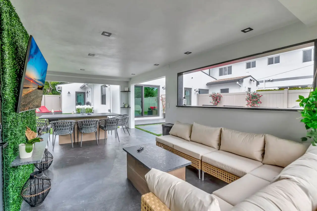 Outdoor dining area with a BBQ grill in a contemporary 3-bedroom duplex