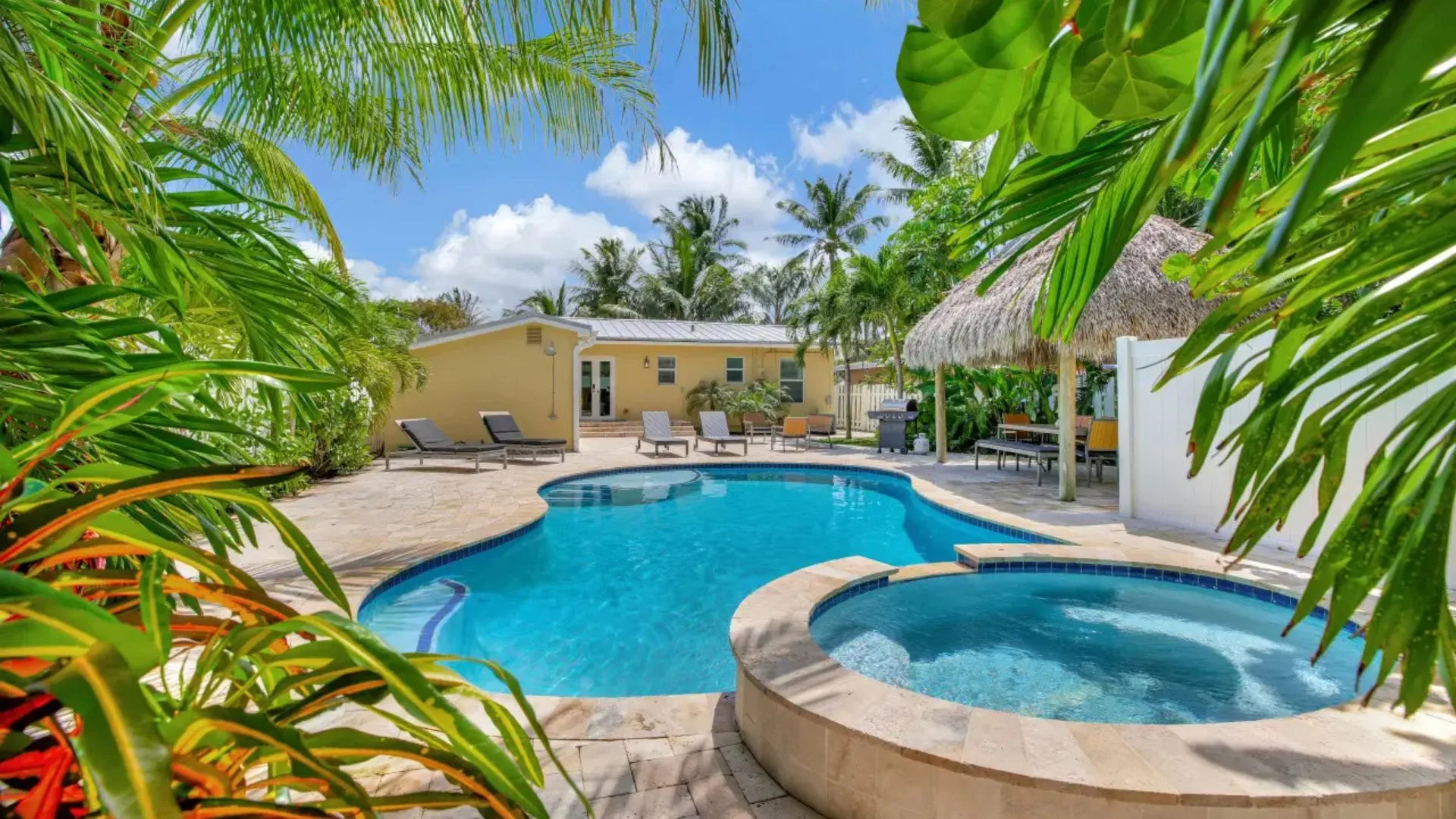 Charming Fort Lauderdale vacation rental with private heated pool, hot tub, tropical landscaping, and Tiki hut—just minutes from the beach and Wilton Drive.