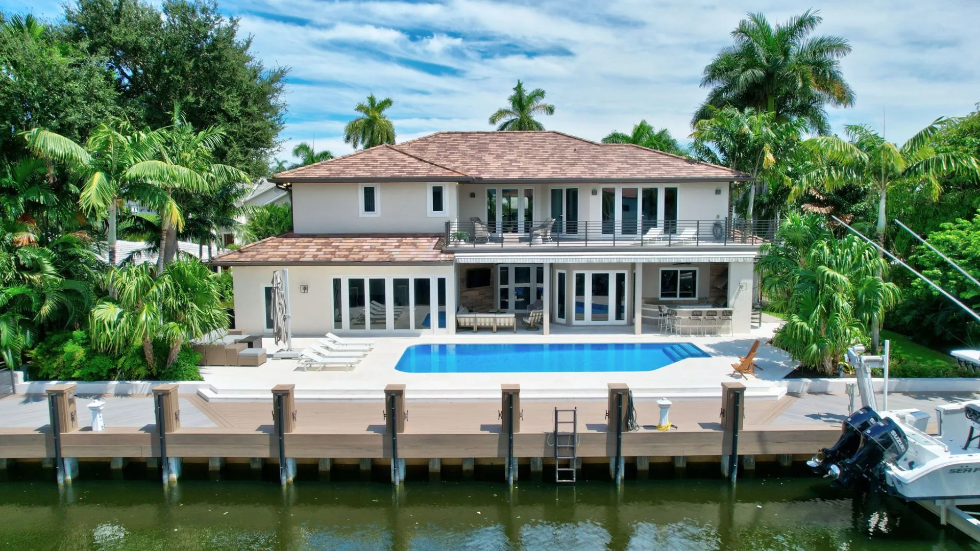 Luxury 6-bedroom waterfront vacation rental estate in Fort Lauderdale’s Las Olas Isles with private dock, heated pool, and outdoor bar.