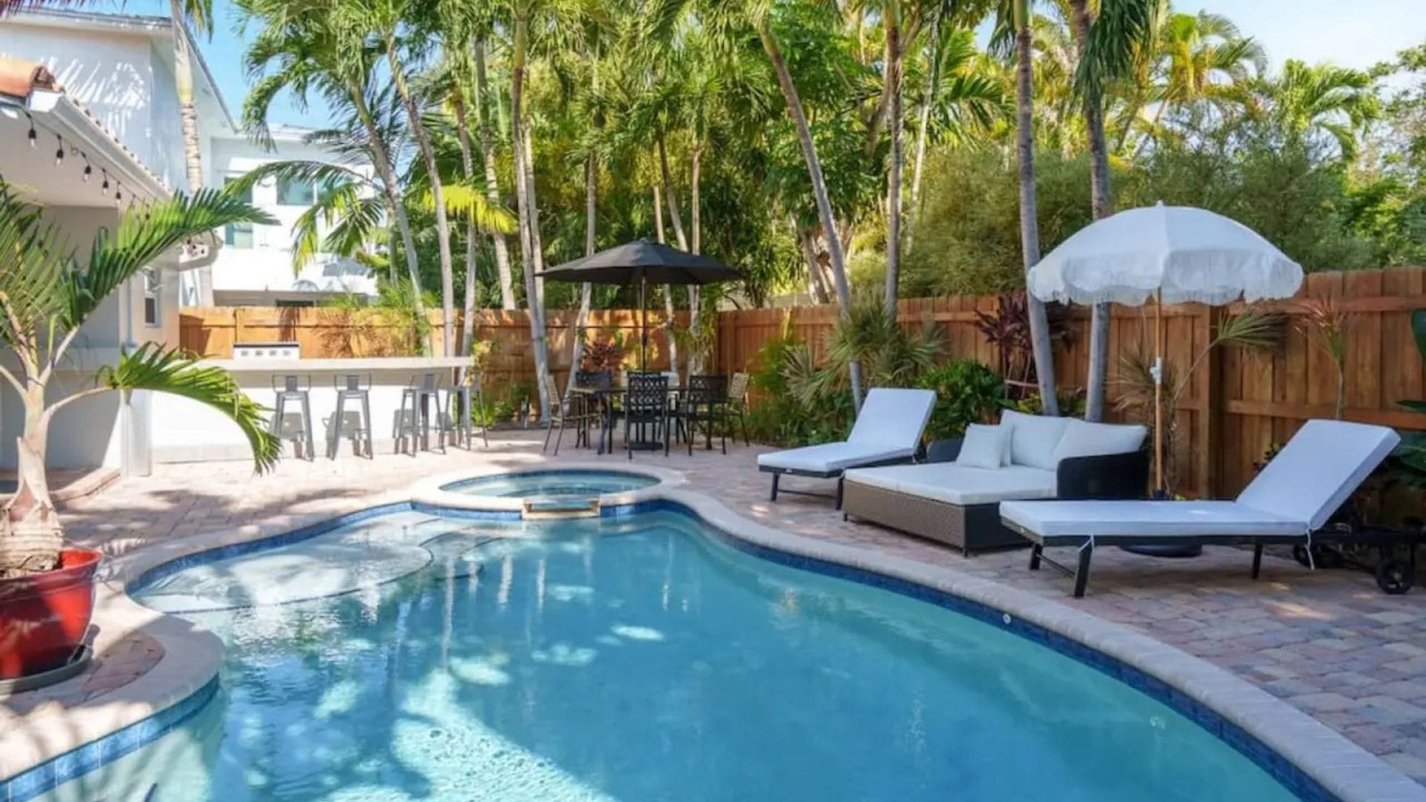 Chic 3-bedroom Fort Lauderdale vacation rental in Victoria Park featuring a heated pool, spa, smart TVs, and modern interiors near Las Olas Boulevard and the beach.