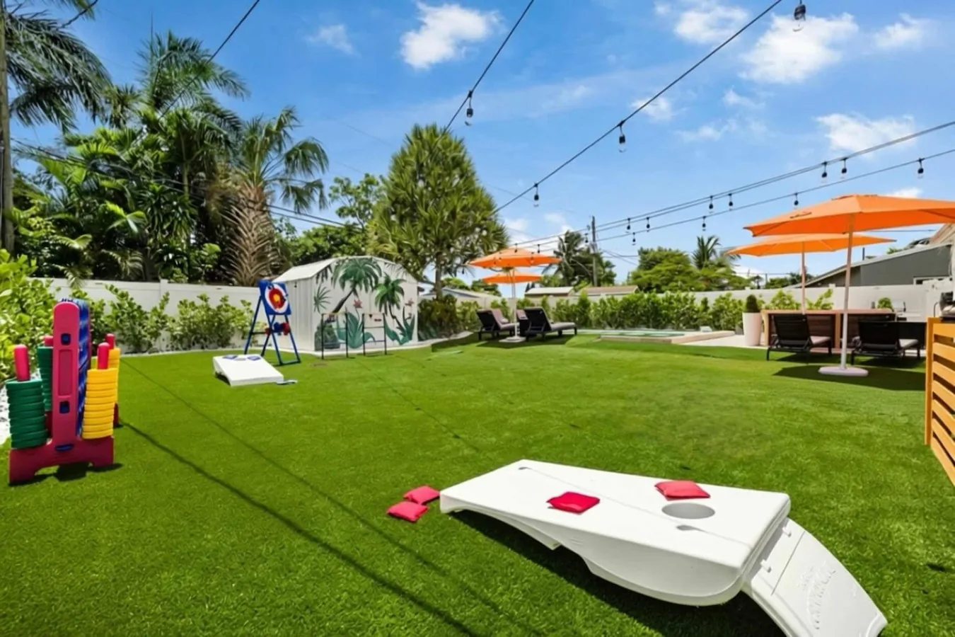 Backyard games including cornhole, jumbo Connect 4 and axe throwing under string lights at Casa Palma